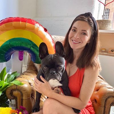 Georgina Blackledge holding her favorite dog, the French Bulldog and posing for a photo shoot.